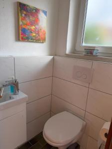 a bathroom with a white toilet and a window at Casa Jo und Jo in Pfullendorf +4 photos