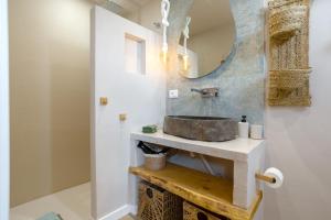 a bathroom with a sink and a mirror at Oceania Villa B, Private Pool in Chayofa +25 photos