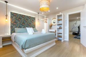 a bedroom with a bed with a large wall art at Oceania Villa B, Private Pool in Chayofa