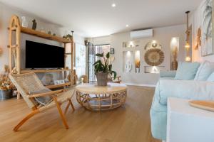 a living room with a blue couch and a table at Oceania Villa B, Private Pool in Chayofa