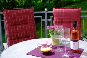 a bottle of wine sitting on a table with glasses at altes forsthaus schotten in Schotten +31 photos