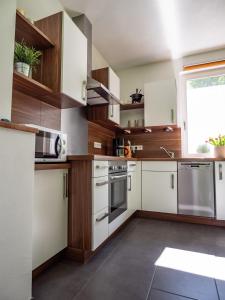 a kitchen with white cabinets and a window at altes forsthaus schotten in Schotten