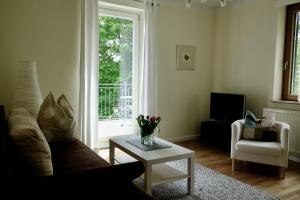 a living room with a couch and a table and a window at altes forsthaus schotten in Schotten