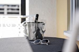 a table with two glasses and a pair of scissors at Andrea in Langenargen +22 photos