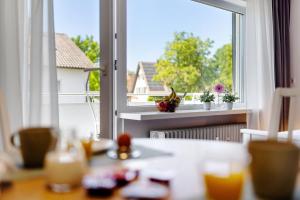 a room with a window and a table with food at Andrea in Langenargen