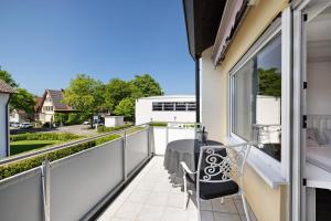 a balcony with a table and a view of a street at Andrea in Langenargen