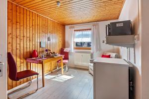 a small room with a desk and a table with chairs at Haus Am Bühl in Schönau im Schwarzwald