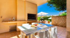 a kitchen and dining room with a table and chairs at Ca Nostra in Son Servera