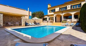 a swimming pool in front of a house at Ca Nostra in Son Servera