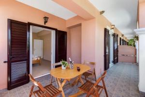 a dining room with a wooden table and chairs at Apollon Apartment in Póndi