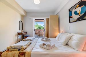 a bedroom with a large bed with two towels on it at Apollon Apartment in Póndi