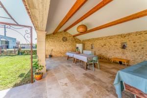 a dining room with a table and chairs and a window at Lila Mas in Camaret-sur-Aigues