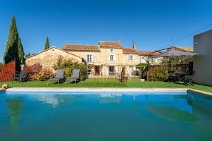 a swimming pool in front of a house at Lila Mas in Camaret-sur-Aigues