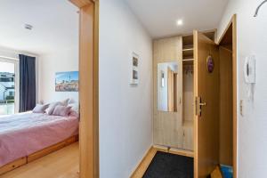 a bedroom with a bed and a door to a room at Fewo Willingenliebe Meinecardplus in Willingen