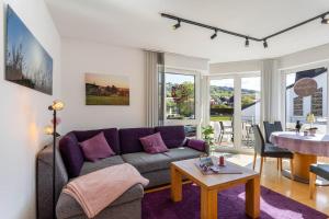 a living room with a couch and a table at Fewo Willingenliebe Meinecardplus in Willingen