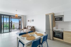 a kitchen and living room with a table and chairs at Yucas Villa 14 in San Bartolomé