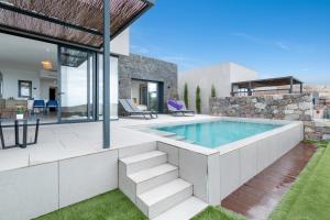 a house with a swimming pool and a patio at Yucas Villa 14 in San Bartolomé