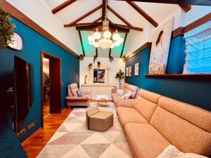 a living room with blue walls and a couch at The red House in Schönecken