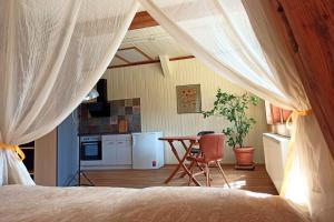 a bedroom with a bed and a table and a kitchen at Bahnhof Durlesbach in Bad Waldsee