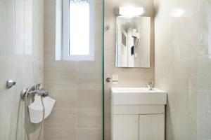 a bathroom with a sink and a mirror at Iguana studio 7 in Preveza +14 photos