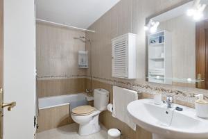 a bathroom with a toilet and a sink at Casa Candido 2 in Playa Honda +12 photos