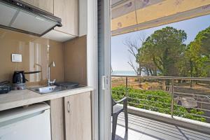 a kitchen with a view of the ocean from a balcony at Iguana studio 7 in Preveza