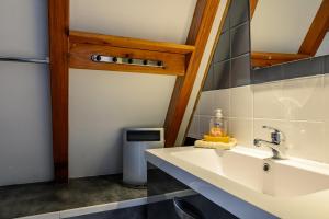 a bathroom with a sink and a mirror at Gite Gewurz n°4 à Kaysersberg in Kaysersberg