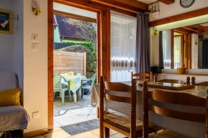 a dining room with a table and a view of a patio at Gite Gewurz n°4 à Kaysersberg in Kaysersberg +17 photos