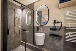 a bathroom with a shower and a sink and a mirror at Avia Living Maria in Brunico +17 photos