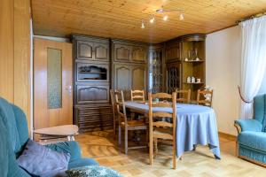 a dining room with a table and chairs at Gîte De Pipala in Mittlach +21 photos