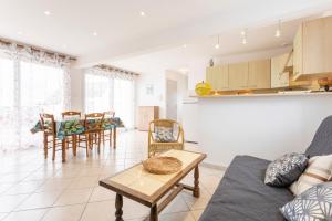 a living room with a couch and a table at Maisonette face à la mer in Trégunc