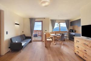 a living room with a couch and a table at Hauserhof in Lagundo