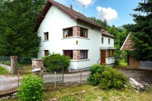 a white house with a fence in front of it at Gîte De Pipala in Mittlach
