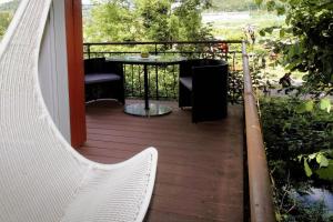 a porch with a table and chairs on a balcony at Gästehäusle Haag in Waldshut-Tiengen +7 photos