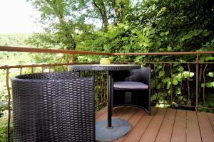 a table and chairs on a wooden deck at Gästehäusle Haag in Waldshut-Tiengen