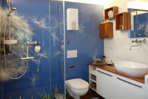 a blue bathroom with a toilet and a sink at Gästehäusle Haag in Waldshut-Tiengen