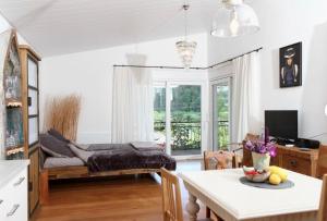 a living room with a bed and a table at Gästehäusle Haag in Waldshut-Tiengen