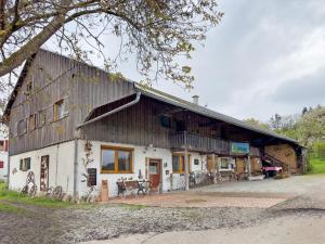 a large building with a gambrel roof at Ferienhaus am Ried in Ostrach