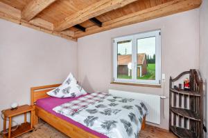 a bedroom with a bed and a window at Salerhof in Bad Wurzach