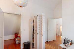 a room with white walls and a white refrigerator at Skyline-Blick in Bad Soden am Taunus