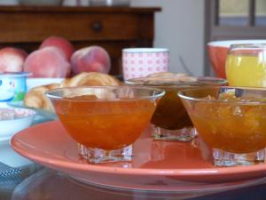 a red plate with three bowls on top of a plate at La Chambre aux Oiseaux in Cayriech +12 photos