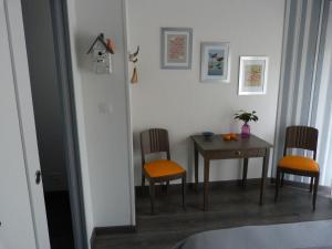 a dining room with a table and two chairs at La Chambre aux Oiseaux in Cayriech