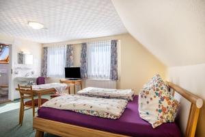 a bedroom with two beds and a desk with a computer at Haus Zapf in Kressbronn am Bodensee
