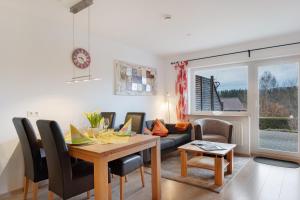 a living room with a table and a couch at Haus Intlekofer in Lenzkirch
