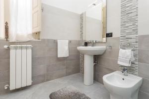 a bathroom with a sink and a toilet and a mirror at La Papuzzella in Puntalazzo +20 photos