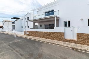 a street view of a white house at Barlovento Apartment in Playa Honda +12 photos