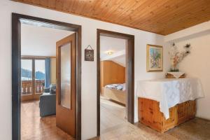 a room with a bed and a room with a table at Haus Prossliner in Tesimo