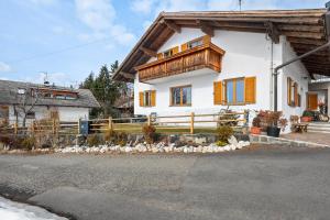 a white house with a wooden fence in front of it at Haus Prossliner in Tesimo