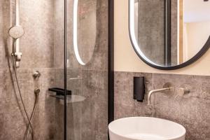 a bathroom with a shower and a sink at Avia Living Anna in Brunico +14 photos