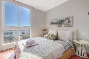 a bedroom with a bed and two windows at Traviata in Cap Blanc +22 photos